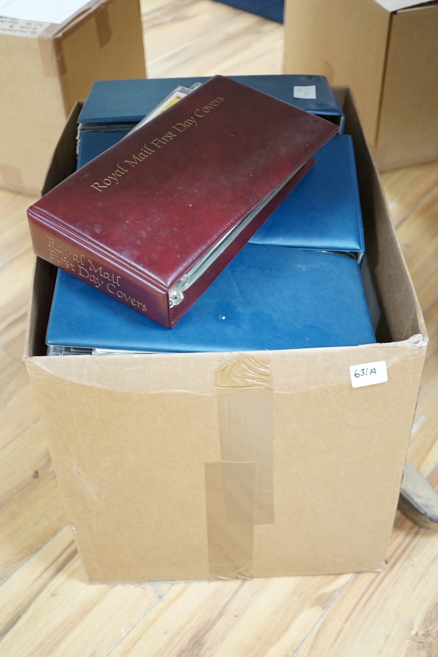 A box of UK and European First Day Covers in various albums